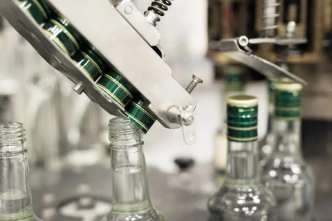 The mechanism of the automatic bottle capping machine. Stock Photos