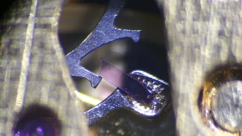 Mechanism of cheap watch under microscope  - 4K Stock Footage 125384790