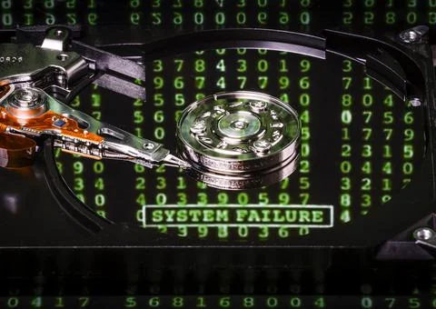 The mechanism of a computer hard disk drive with words "System Failure" Stock Photos