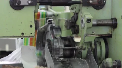 The mechanism of the packaging machine packages the candy bars Stock Footage 128643122