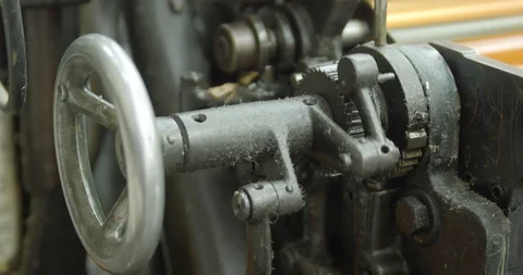 Mechanism with rotating gears. The cogs are turning the ink rollers on a Stock Footage 102192755