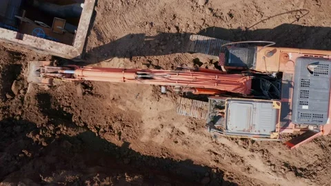 Mechanization of construction works. A full-rotary excavator digs a rectangular Stock Footage 157694491