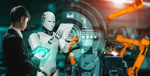 Mechanized industry robot and human worker working together in future factory Foto stock