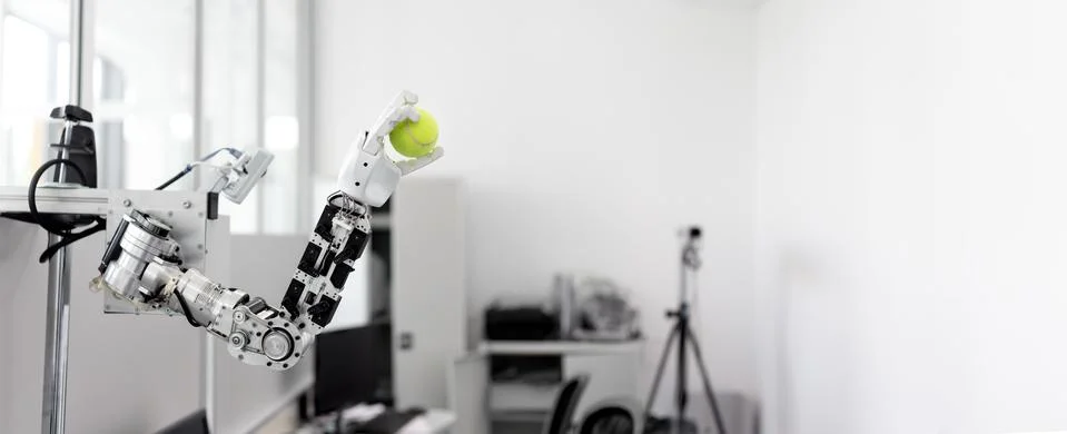 Mechanized robot hand holds the objects drawn a tennis ball Stock Photos