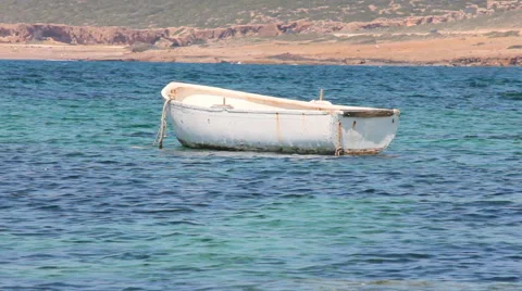 Med Close up White rowing boat bobbing on an azure sea in Cyprus Stock Footage 42190159