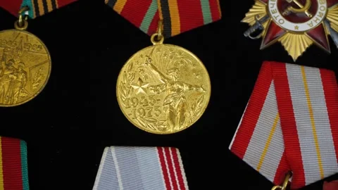 Medals lying on a black surface with visible inscriptions and symbols Video stock 312742281