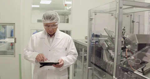 Medecine specialist using tablet while taking inventory in pharmaceutical Stock Footage 101097757