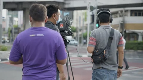 Media Production Team Setup Camera For An Outdoor Interview Coverage In Video stock 211393971