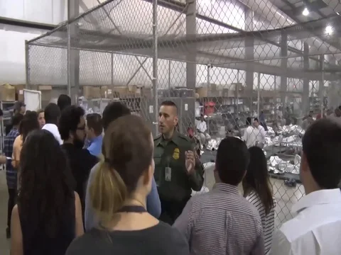 Media visit immigration processing center at McAllen, Texas Stock Footage 91169671