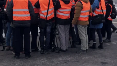 Media in work helmet and reflective vest at plant Stock Footage 70939631