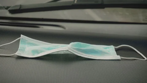 Mediacal protective mask on front panel of driving car during pandemic of Video stock 127692213