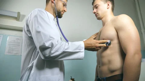 Medic checking chest of athletic guy in ... | Stock Video | Pond5