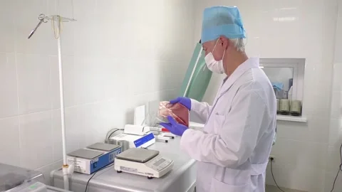 A medic examines a container of blood Stock Footage 139824138