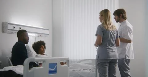 Medic holds digital tablet computer and explains test results Stock Photos