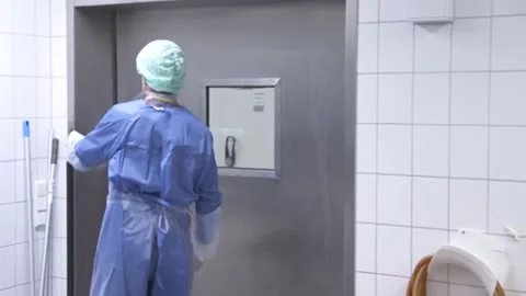 Medic leaves the ward. View from the back Video stock 133535952