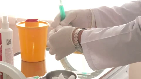 The medic opens the ampoule and prepares the syringe for injection Stock Footage 130272516