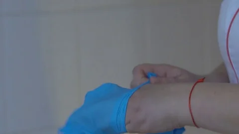 Medic wears gloves Stock Footage 85369012