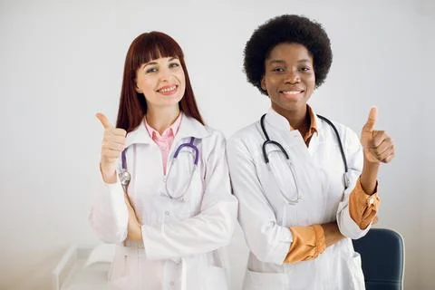 Medical aid, insurance, health care and medicine concept. Two multiracial Stock Photos
