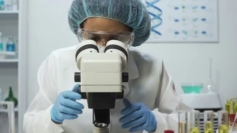 Medical analyst zooming on microscope while doing DNA analysis, medical test Stock Footage 73709592
