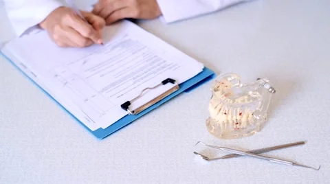 Medical assistant signing document Stock Footage 65775458