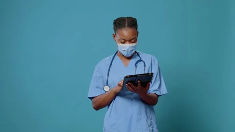 Medical assistant using digital tablet with touch screen Stock Footage 164402026