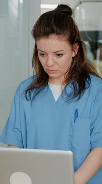 Medical assistant working with computer to help doctor Stock Photos