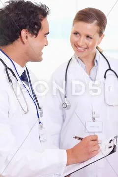 Medical assistants with patient record Stock Photos