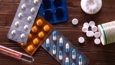 Medical background: tablets, thermometer, stethoscope lie on a white table. Stock Footage 82965227