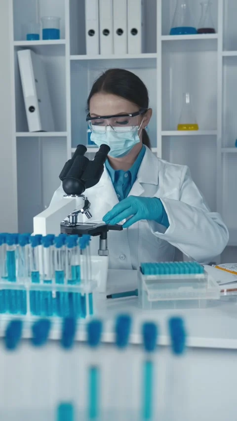 A medical bacteriologist studies the properties of bacteria and their effects on Stock Footage 276313720