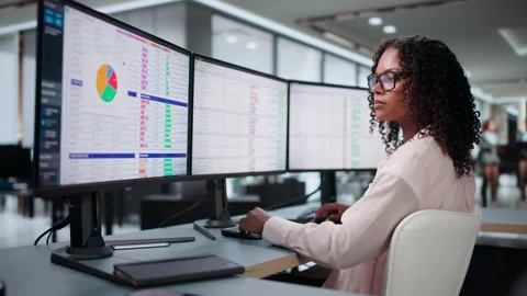 Medical Biller Carefully Reviews Coding Data On Computer Stock Footage 339909686