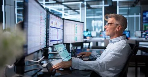 Medical Billing Analyst Studies Coding Spreadsheets On His Office Computer Ca Stock Photos