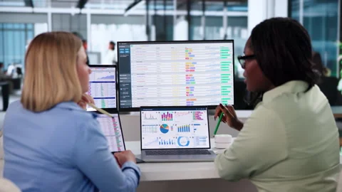 Medical Billing Analysts Review Coding Data On Computers Stock Footage 343885379