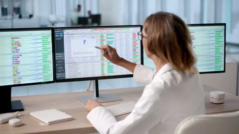 Medical Billing Coder Analyzing Healthcare Data On Computer Screens Stock Footage 336372221
