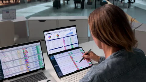 Medical Billing Coder Carefully Reviews Spreadsheet Data Stock Footage 336794017