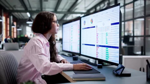 Medical Billing Coder Carefully Reviews Patient Data Using Advanced Software Stock-Footage 345334443