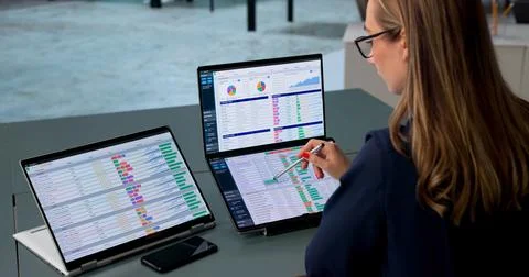 Medical Billing Coder Carefully Reviews Patient Data On Laptop Screen. Stock Photos