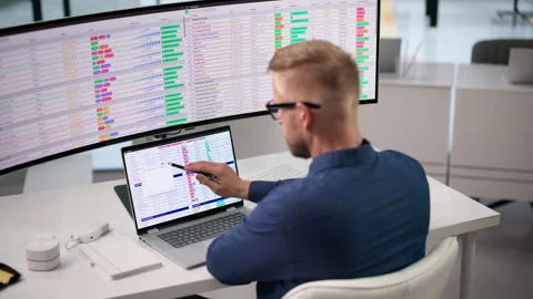 Medical Billing Coder Reviews Spreadsheet Data Using Laptop Stock Footage 347283573