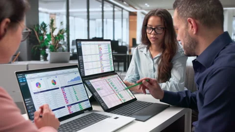 Medical Billing Coder Reviews Spreadsheet Data With Diverse Team Stock Footage 347303829