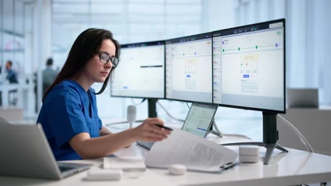 Medical Billing Specialist Reviews Coding Details On Laptop Stock Footage 338170984