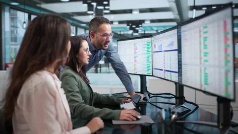 Medical Billing Specialists Review Coding Spreadsheets On Computers Stock-Footage 347906201