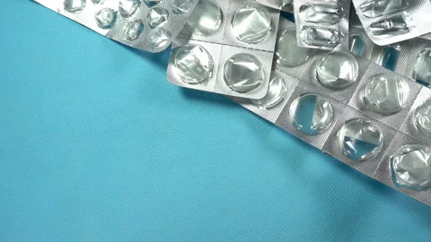 Medical capsules fall on empty blisters from pills in slow motion Stock Footage 132508577