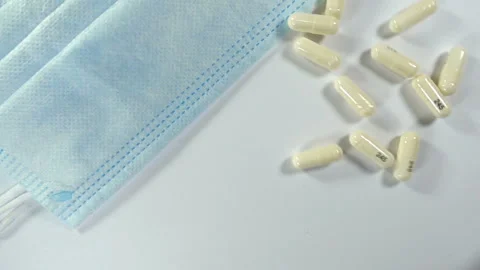 Medical capsules fall in slow motion Stock Footage 196079088
