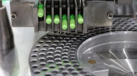 Medical capsules packing process by machine Stock Photos