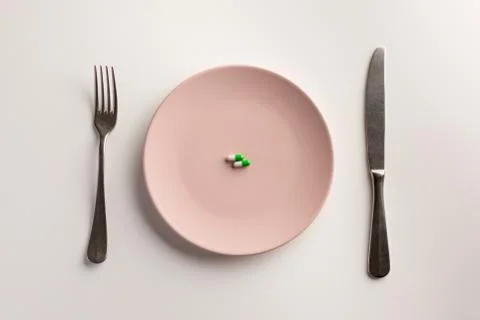 Medical capsules on a plate. Flat lay. Stock Photos