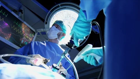 Medical Caucasian surgical team in scrubs performing Laparoscopy surgery on the Stock Footage