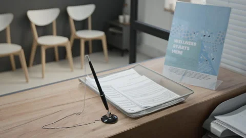 Medical Check-in Forms and Wellness Flyer on Reception Desk Stock Footage 332664909