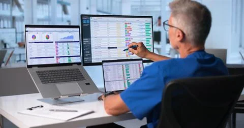 Medical Coder Carefully Checking Hospital Billing Codes On Laptop Screen. Stock Photos