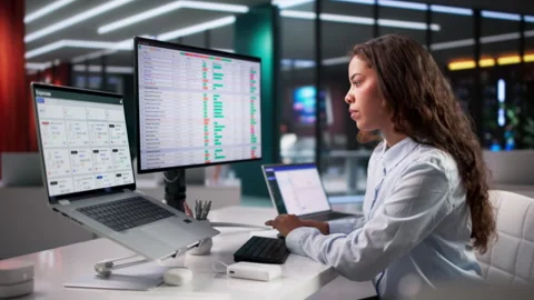 Medical Coder Carefully Reviewing Billing Codes On Laptop Stock Footage 335882349
