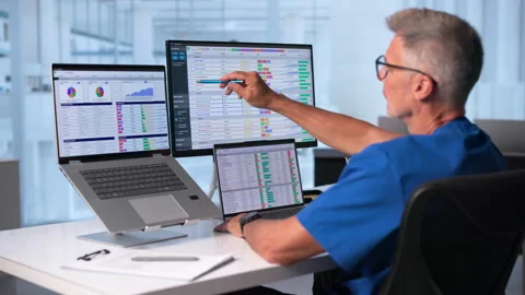 Medical Coder Carefully Reviewing Billing Codes On Laptop Stock-Footage 345319640