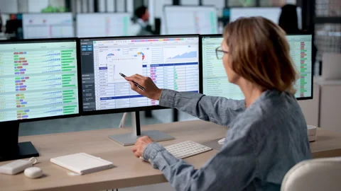 Medical Coder Carefully Reviews Billing Codes On Computer Screens Stock Footage 337631962